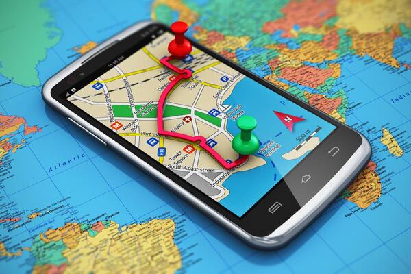 graphic of an iphone with maps pulled up over an atlas