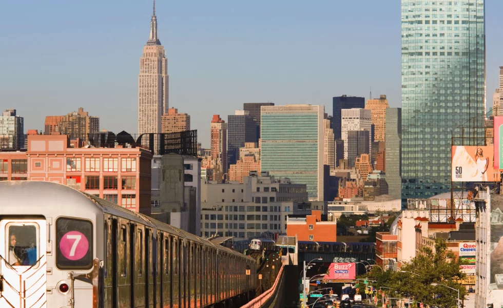 the 7 train with the city in the background