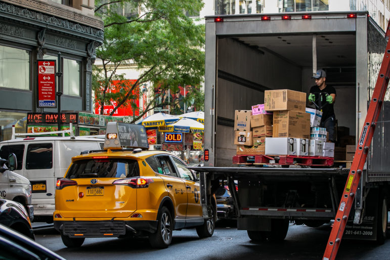 man unloading boxes off a truck in NYC
