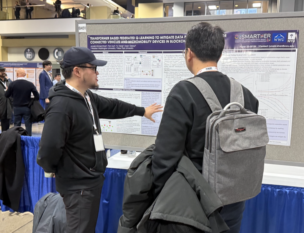 Fan Zuo explaining his poster to an attendee at TRB