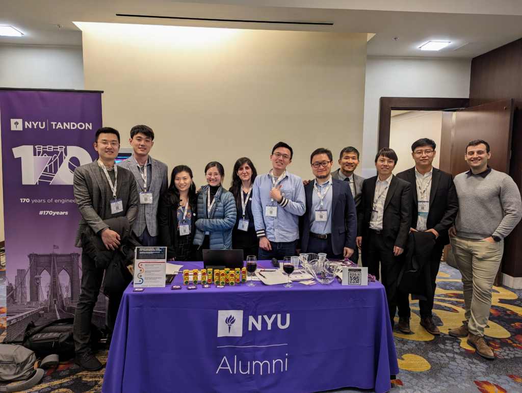 students manning the NYU alumni welcome table