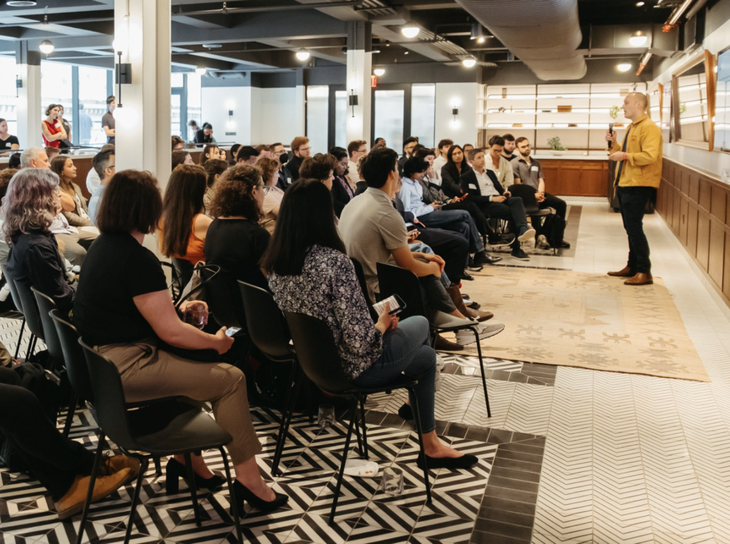 audience listening to a speaker in an office