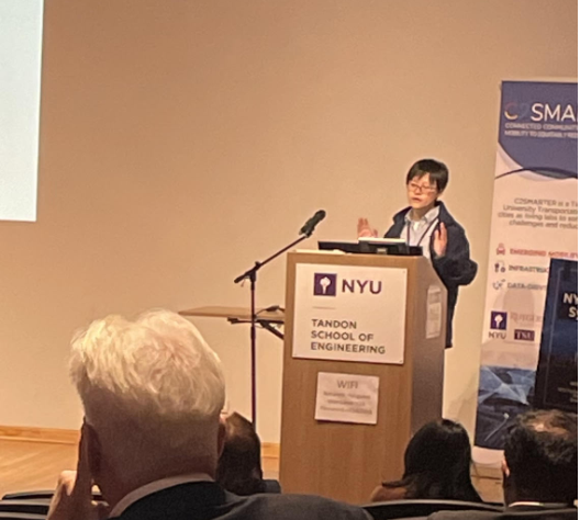 professor presenting her work at the podium