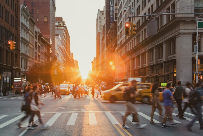 Pedestrians crossing a busy intersection in Manhattan
