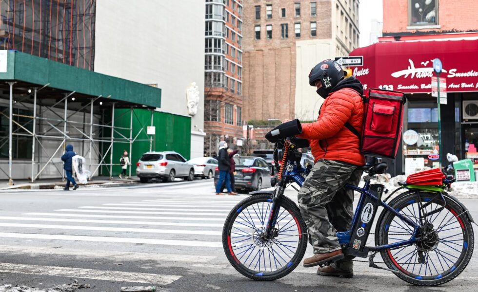 e-bike worker at a traffic light