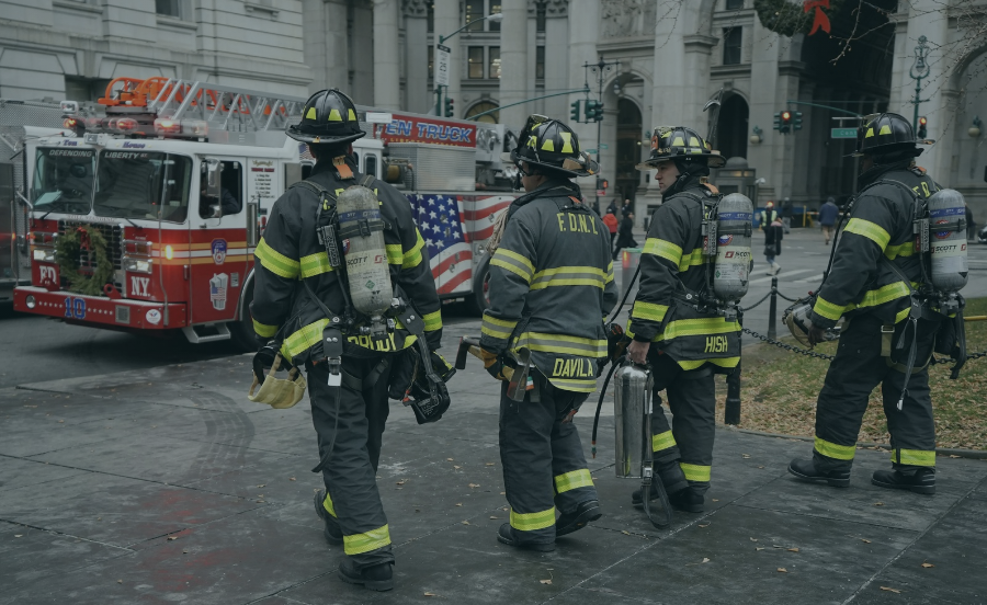 FDNY firefighters walking toward a fire truck