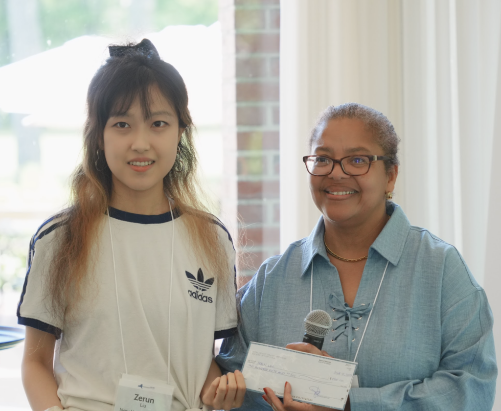 Image of student researcher Zerun Liu receiving her 1st place award money at ITS NY.